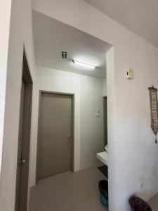 a bathroom with a door and a white wall at AYAAN Muslimah home at Golden Hill near Night Market in Brinchang +21 photos
