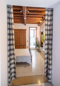 a bedroom with a bed and a wooden ceiling at Torre Cà Emo - Monolocale "L'Antico portico" in Vittorio Veneto