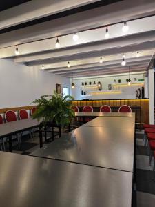 a conference room with a table and red chairs at Duarto house, Sauna and Hot Tub in Šiaudinė
