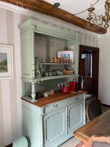 a kitchen with a large white cabinet in a room at La Casa Verde B&B in Trivero