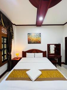 Postel nebo postele na pokoji v ubytování PhaiLin Hotel