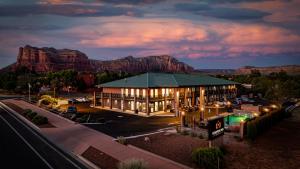 a building at night with mountains in the background at Kokopelli Inn Sedona, Trademark Collection by Wyndham in Sedona