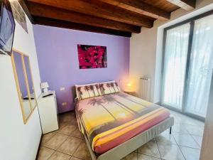 a bedroom with a bed and a painting on the wall at New Apartment on Ground Floor with Terrace in Desenzano del Garda +25 photos