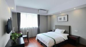 a hotel room with a bed and a window at GreenTree Inn Jiangsu Suzhou New District Science and Technology College Business Hotel in Suzhou +212 photos