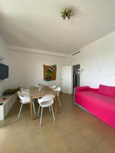 a living room with a red couch and a table at Attico Sabbia D'oro - V Apartments in Gallipoli