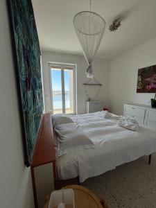 a bedroom with a bed and a large window at Attico Sabbia D'oro - V Apartments in Gallipoli