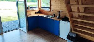 a kitchen with a sink in a tiny house at Przy jeziorze in Kaliska Kośierskie +10 photos