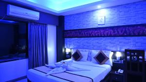 a bedroom with a bed with white sheets and pillows at Hotel Durene in Bhubaneshwar +16 photos