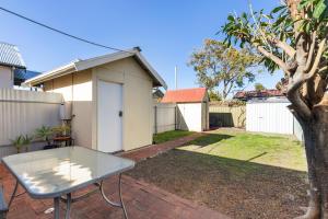 a table in the backyard of a house at Bath Street Cottages in Adelaide