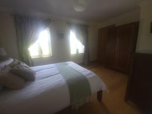 Ένα ή περισσότερα κρεβάτια σε δωμάτιο στο Gullistan Room, Kilpipe House