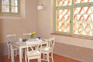 a dining room with a table and chairs and a window at Le Moraiole in Massa Marittima