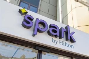 a sign for a store in front of a building at Spark by Hilton Wuppertal City Centre in Wuppertal