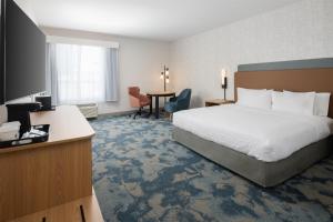 a hotel room with a large bed and a desk at Hampton Inn by Hilton North Hollywood in North Hollywood +32 photos