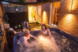 two women are sitting in a jacuzzi at Chester Apartments in Chester