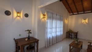 a living room with a table and a window at Lake side haven villa in Tangalle