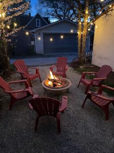 a group of chairs around a fire pit at night at Cabernet Sauvignon Escape in Calgary
