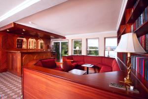 a living room with a red couch and a table at The Lodge @ Harvey's Point in Donegal