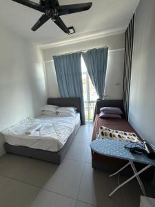 a bedroom with two beds and a ceiling fan at AYAAN PENTHOUSE at Golden Hill Night Market View in Brinchang