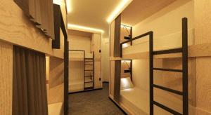 a room with two bunk beds and a hallway at Capsule@Hive Bugis in Singapore +82 photos