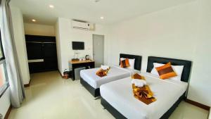 a living room with a white couch and a desk at Noble Boutique Hotel Chiang Mai By J&S Property in Chiang Mai +5 photos