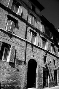 a black and white photo of an old brick building at Casalbergo in Siena