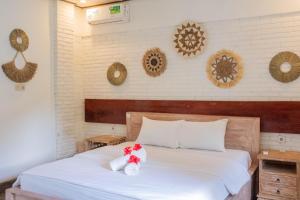 Postel nebo postele na pokoji v ubytování Bramasa Ubud Guest House