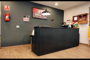 a restaurant with a black bar in a room at RROOMS Hotel La-Maison in Lucknow