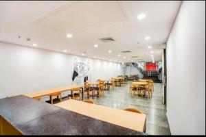 a restaurant with tables and chairs in a room at RROOMS Hotel La-Maison in Lucknow
