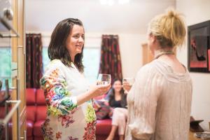two women holding wine glasses in a room at Chester Apartments in Chester
