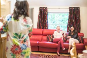 two women sitting on a couch in a living room at Chester Apartments in Chester