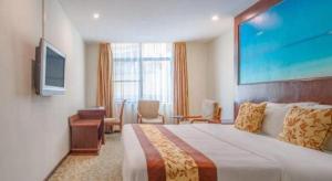 a hotel room with a large bed and a television at Zhaoqing Shanshui Fashion Hotel Duanzhou Road Branch in Zhaoqing