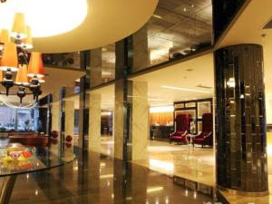 a lobby with chairs and a table in a building at Downtown Hotel in Zhuhai
