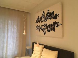 a room with a couch and a painting of horses on the wall at Huswell Artsy Family Apartment in City Center in Antwerp