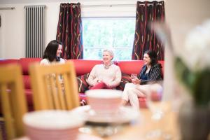 a group of three women sitting on a couch at Chester Apartments in Chester