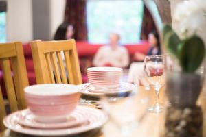a table with plates and a glass of wine at Chester Apartments in Chester