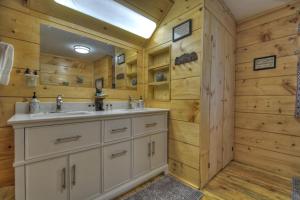 a bathroom with a sink and a mirror at Bear Naked Hideaway - Relax in the hot tub with sounds from the nearby creek in Epworth +42 photos