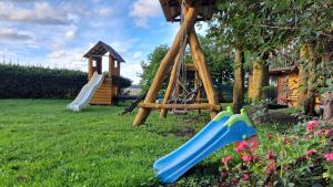 a playground with a slide and a swing at Strazdiņi in Saraiķi
