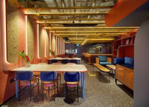 a room with a table and chairs in a room at Hotel Soloha @ Chinatown in Singapore