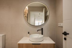 a bathroom with a sink and a mirror at Loft América 41 B in Melide +3 photos