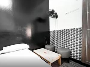 a bedroom with a bed and a shower and a table at Radom Residence in Jakarta