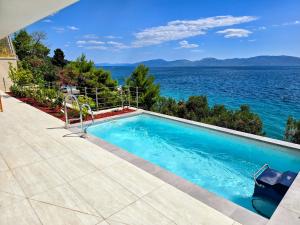 a swimming pool with a view of the water at Villa Deluxe Zaostrog in Zaostrog