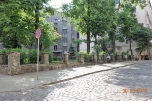 a street with a no parking sign on a sidewalk at Riga Old Town River View with balcony in Rīga