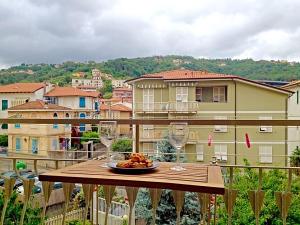 a plate of food sitting on a table on a balcony at Casa Vacanze Luli in La Spezia