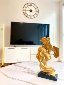 een gouden leeuwenbeeld voor een tv bij Luxurious 2 Bedroom - Water View and Parking in Manchester