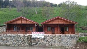 a building with a sign in front of it at Aslan Dağ Evleri in Uzungöl
