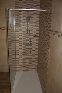 a shower with a glass door in a bathroom at Casa Rural Torres in Valdenoceda +30 photos