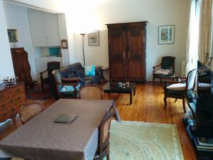 a living room with a couch and a table and chairs at Le California in Biarritz +16 photos