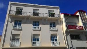a white building with balconies on the side of it at Le California in Biarritz