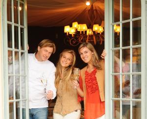 a group of people standing in a doorway holding wine glasses at De Zevende Hemel in Merendree