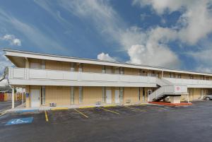 a large yellow building with a parking lot at Alamo Inn & Suites in Gillette